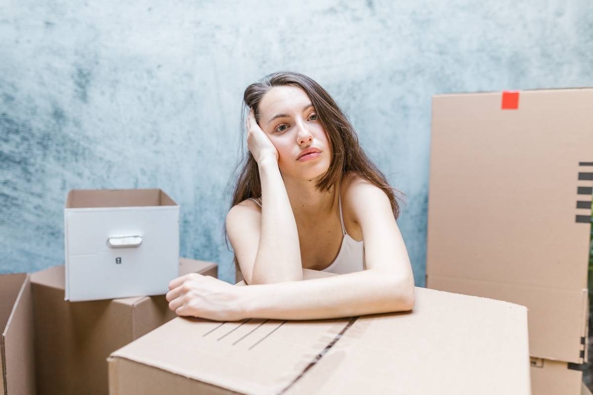 woman leaning on cardboard box